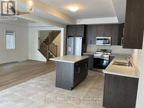 Pelham (Fonthill) apartment for rent - A modern kitchen with dark wood cabinets and stainless steel appliances.