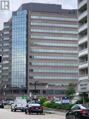 Hamilton (Central) condo for rent - A tall building with a glass facade is in the background.