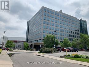 Hamilton (Central) condo for rent - A large office building with the Real One Realty Inc. logo on the top left corner.