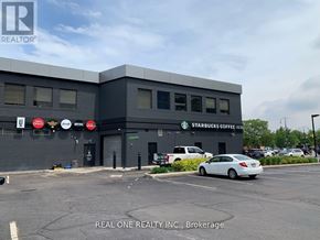 Hamilton (Central) condo for rent - A grey building with a Starbucks Coffee sign on it.