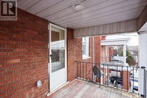 Ottawa duplex for rent - A balcony with a brick wall and a white door.