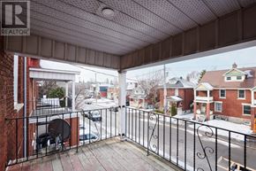 Ottawa duplex for rent - A balcony with a metal railing overlooks a residential street.