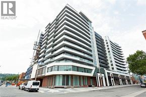 Hamilton condo for rent - A modern multi-story building with a glass facade is under construction.