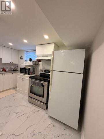 Toronto (Newtonbrook West) apartment for rent - A white kitchen with a refrigerator on the right.