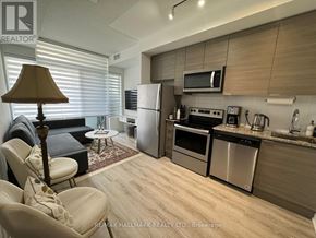 Toronto (Bayview Village) condo for rent - A modern kitchen with a refrigerator, oven, and microwave.