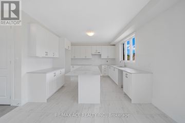Otonabee-South Monaghan apartment for rent - A white kitchen with a large island in the middle.