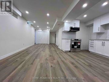 Aurora (Bayview Wellington) apartment for rent - A kitchen with white cabinets and a wooden floor.