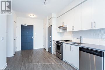Hamilton (Beasley) condo for rent - A kitchen with white cabinets and a blue door.