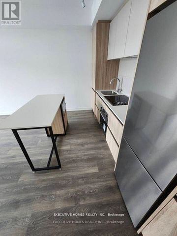 Vaughan (Beverley Glen) condo for rent - A modern kitchen with a table and chairs.