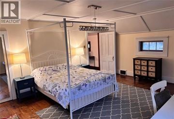 Fort Erie apartment for rent - A bedroom with a four poster bed and a dresser.