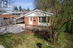 London North (North K) apartment for rent - A small building with a black door is surrounded by a wooden fence and covered in snow.