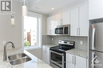 Ottawa apartment for rent - A modern kitchen with a stainless steel oven and microwave.