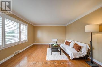 Thorold (Thorold Downtown) apartment for rent - A living room with a white couch and a wooden floor.