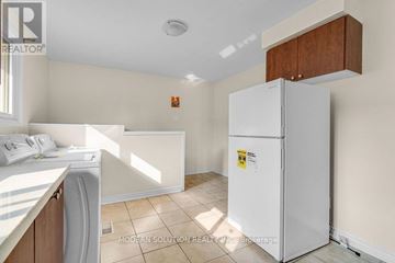 Brampton (Downtown Brampton) apartment for rent - A white refrigerator in a kitchen with a washing machine and a window.