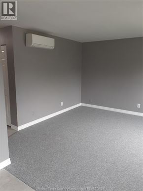 Windsor apartment for rent - A bathroom with a sink, mirror, and toilet.