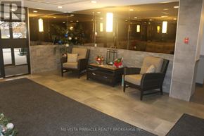 London North (North C) condo for rent - A well-lit waiting area with a Christmas tree and chairs.