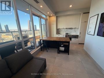 Vaughan (Vaughan Corporate Centre) condo for rent - A modern kitchen with a view of the cityscape outside the large windows.