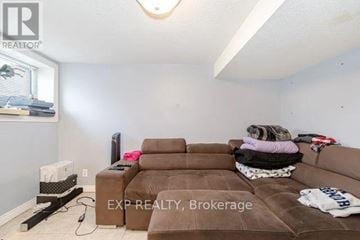 Brampton (Downtown Brampton) apartment for rent - A living room with a brown couch and a flat screen TV.