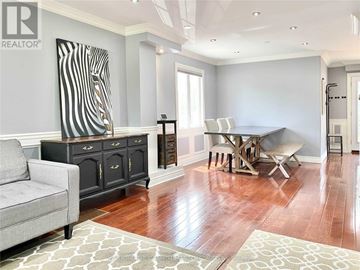 Toronto (Kennedy Park) apartment for rent - A living room with a grey couch and a wooden floor.