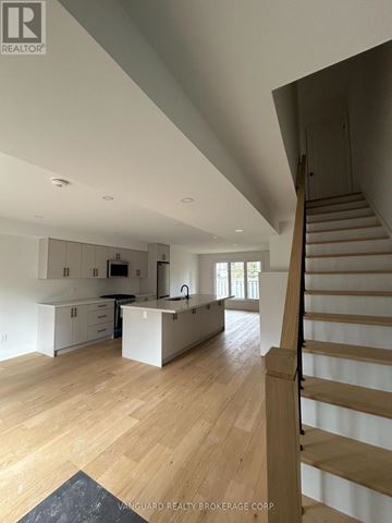 Toronto (Lansing-Westgate) apartment for rent - A spacious kitchen with a staircase on the right side.
