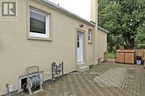 Toronto (Wexford-Maryvale) apartment for rent - A house with a green lawn and a fence in front of it.