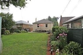 Toronto (Wexford-Maryvale) apartment for rent - A living room with a couch, chair, and exercise bike.