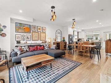 Surrey townhouse for rent - A modern living room with a grey couch, a wooden coffee table, and a dining table with chairs.