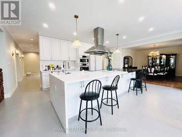 Vaughan (Vellore Village) apartment for rent - A modern kitchen with white cabinets and a large island.