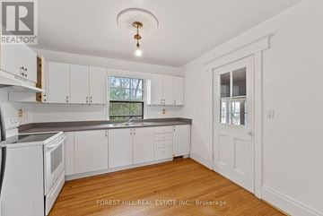 Richmond Hill (Mill Pond) multi-family for rent - A kitchen with white cabinets and a window.