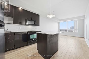 Toronto (Banbury-Don Mills) condo for rent - A modern kitchen with black cabinets and a large island.