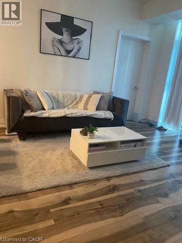 Grimsby condo for rent - A living room with a couch, a coffee table, and a painting on the wall.