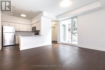 Toronto (Dovercourt-Wallace Emerson-Junction) condo for rent - A spacious kitchen with white cabinets and a refrigerator.