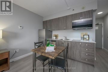 London East (East K) condo for rent - A kitchen with a table and chairs in the middle of the room.