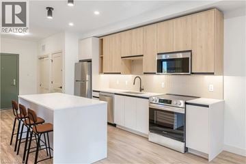 Beamsville condo for rent - A modern kitchen with wooden cabinets and stainless steel appliances.