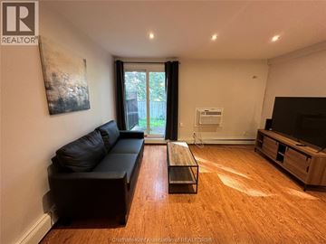 Chatham apartment for rent - A living room with a black couch and a wooden coffee table.