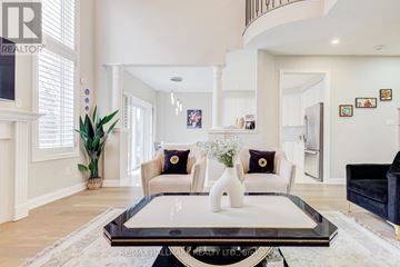 Vaughan (Vellore Village) apartment for rent - A living room with a glass coffee table and a couch with two cushions.