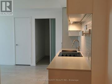 Vaughan (Vaughan Corporate Centre) condo for rent - A kitchen with a stove top oven and a sink.
