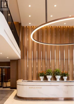 Toronto (Waterfront Communities) condo for rent - A reception area with a marble counter and a sign that says "Maple House".