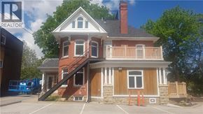 Grimsby apartment for rent - A house with a realtor sign in the background.