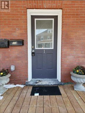 Oshawa (O'neill) apartment for rent - A blue door with a mailbox on the brick wall.