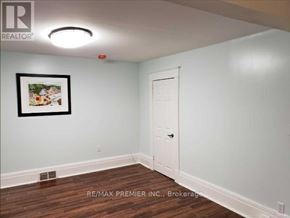 Oshawa (O'neill) apartment for rent - A room with a white door and a picture on the wall.