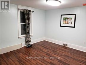 Oshawa (O'neill) apartment for rent - A room with a window and a picture on the wall.