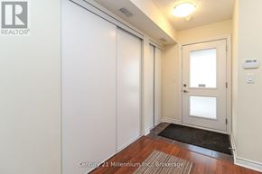 Collingwood condo for rent - A hallway with a door and a mat on the floor.