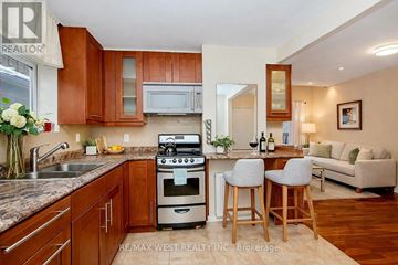 Toronto (Oakwood Village) fourplex for rent - A kitchen with wooden cabinets and a stove top oven.