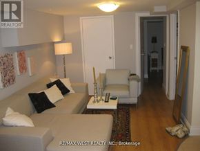 Toronto (Oakwood Village) fourplex for rent - A living room with a couch, chair, and lamp.