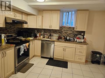 Mississauga (Hurontario) apartment for rent - A kitchen with a black stove top oven and a black trash can.