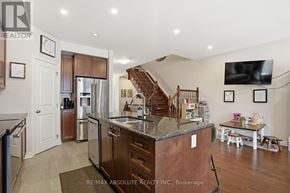 Russell townhouse for rent - A kitchen with a refrigerator, sink, and stove.