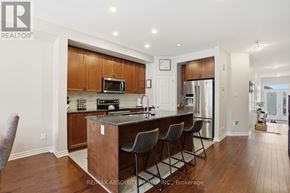 Russell townhouse for rent - A kitchen with a bar and chairs.