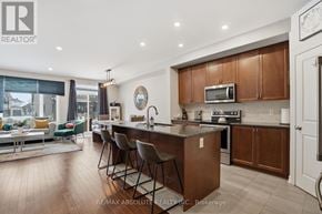 Russell townhouse for rent - A modern kitchen with wooden cabinets and a large island.