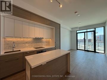 Toronto (Bayview Village) condo for rent - A modern kitchen with a marble backsplash and a view of the city.